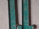 two pieces of green metal sitting on the floor