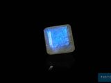 a close up of a square stone with a blue glow on it