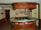 an image of a kitchen with a bar in the middle of the room