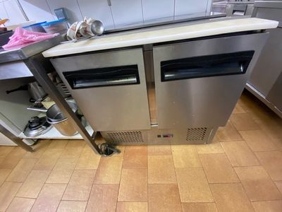 a stainless steel counter top with two ovens on it
