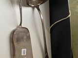 two spoons and a spoon rest on a table
