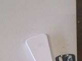 an image of a white refrigerator on a wooden table