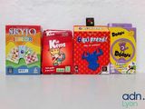 three boxes of kids ' s games are lined up on a table