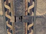 a close up of a wooden ceiling with a clock on it