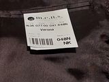 the label is on the back of a black jacket with a white tag