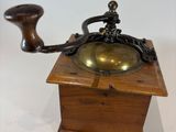 a small wooden box with a brass plate on top of it