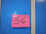 a pink post it on the door of a blue room