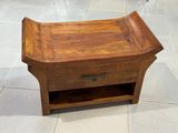 a small wooden table with a drawer on top of it