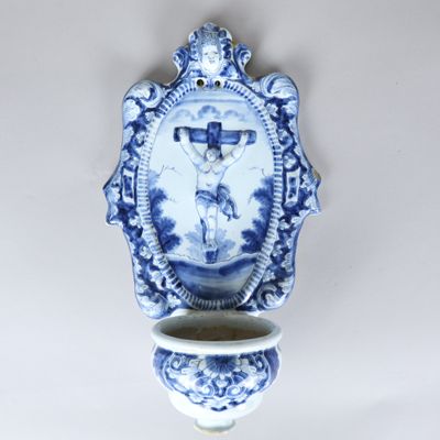 a blue and white vase with a picture of jesus on it