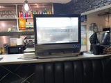 a television that is sitting on a counter in a restaurant