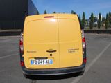 a yellow van that is parked in a parking lot