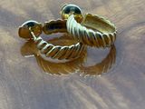 a gold ring on a wooden table with water on it