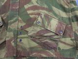 a close up of a camouflage jacket with buttons