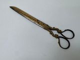 a pair of scissors on a table with a white background