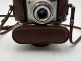 a brown leather strap around the camera