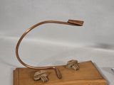 a wooden stand with a lamp and a pair of scissors on it