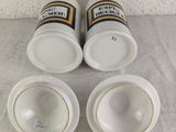 three cups and a saucer sitting on a table with a white table cloth