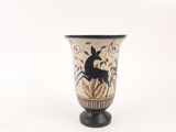 a black and white vase with a picture of a deer on it