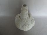 a white vase with a bird on it sitting on a table