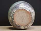 a close up of a vase on a table