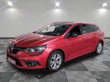 a red car is parked on a checkered floor in a garage