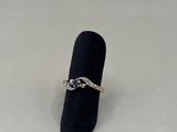 a close up of a ring on a ring holder on a white surface