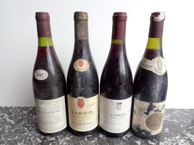 three bottles of wine are lined up on a table