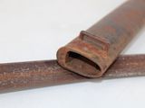 a piece of rusted pipe that is laying on a table