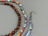 a necklace with a bead and a necklace with a bead on it