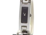 a watch that is sitting on a stand on a white surface