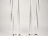 a pair of clear acrylic and brass plated candles