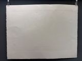 a piece of paper hanging on a black wall