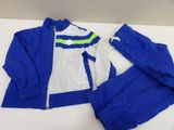 a blue and white jacket and pants sitting on top of a table