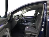 the interior of a car with the door open and the driver ' s seat down