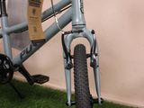 a bicycle that is sitting on the grass in front of a wall