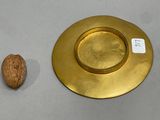 a picture of a nut and a gold plate on a table