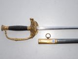 an image of a sword with a gold handle and a black handle