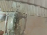 a person that is holding a light bulb in a glass