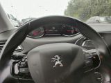 a steering wheel and dashboard of a car on a rainy day