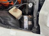 a car engine with an oil can and a battery in it