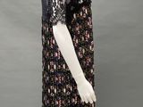 a mannequin wearing a black dress with a floral pattern on it
