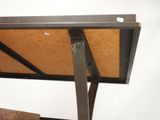 a wooden table with a metal frame on top of it