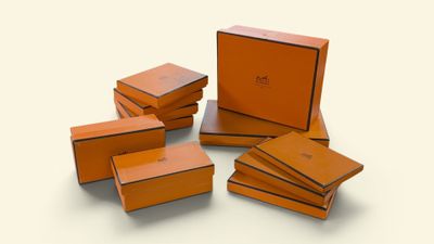 six orange boxes are stacked on top of each other on a white surface
