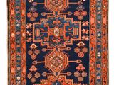 a blue and red rug with a medallion design on it