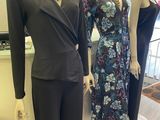 three mannequins in a clothing store display with dresses on display