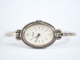 an image of a close up of a wrist watch on a white surface