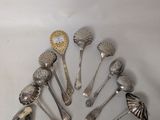 a lot of silver spoons and spoon spoons on the table