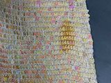 a yellow crochet dress with pink and yellow beads