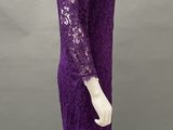 a mannequin wearing a purple lace dress with long sleeves