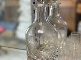 bottles and glasses on a glass shelf in a store